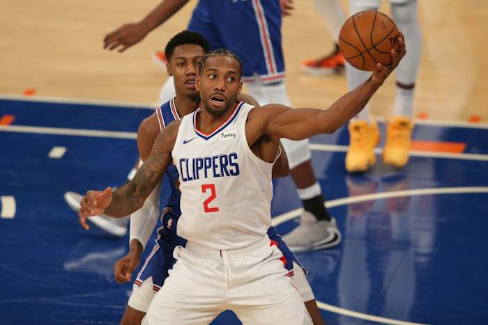 Jan 31, 2021; New York, New York, USA; LA Clippers small forward Kawhi Leonard (2) controls the ball against New York Knicks shooting guard RJ Barrett (9) during the second quarter at Madison Square Garden. Mandatory Credit: Brad Penner-USA TODAY Sports